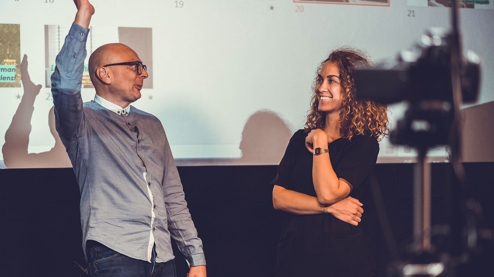 Marcus John Henry Brown coaching a client on the studio stage